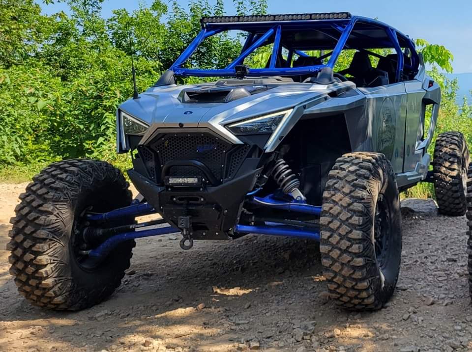 Front view of a side-by-side showing its wheels and off-road tires